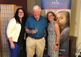 CASA of NH Program Manager Shiloh Remillard, left, and CASA of NH President Marty Sink present CASA Volunteer Advocate Mark Linehan with the 2021 Linda Egbert Outstanding Advocacy Award.
